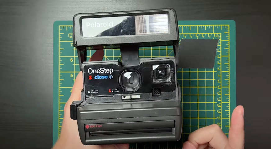 Front view photograph of a black Polaroid OneStep camera.