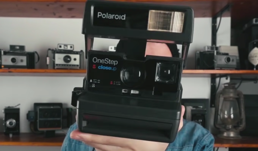 Front view of a black-colored Polaroid 600 camera.