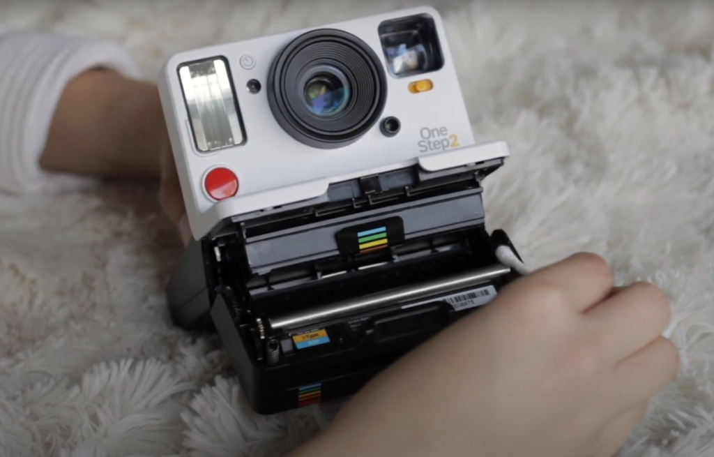 the processing of cleaning a Polaroid cam with a Q-tip